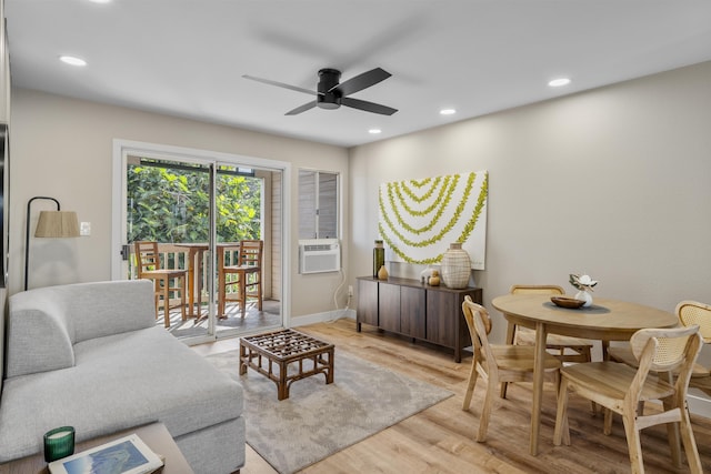 living room featuring light hardwood / wood-style flooring, ceiling fan, and cooling unit