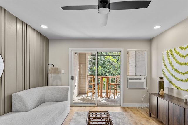 sitting room with ceiling fan, light hardwood / wood-style floors, and cooling unit