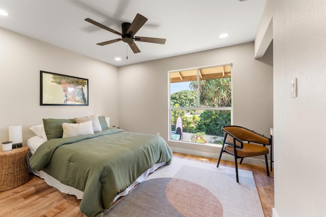 bedroom with ceiling fan and light wood-type flooring