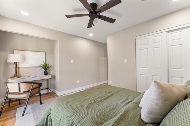 bedroom featuring a closet, light hardwood / wood-style floors, and ceiling fan