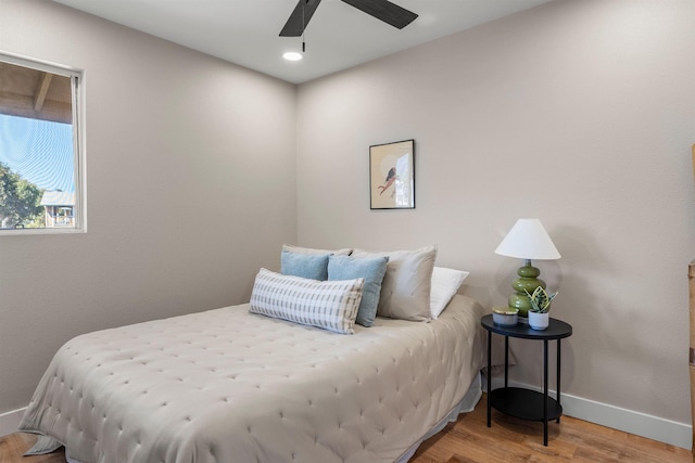 bedroom featuring hardwood / wood-style floors and ceiling fan