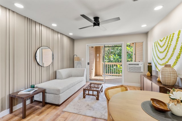 sitting room featuring ceiling fan, light hardwood / wood-style flooring, and cooling unit