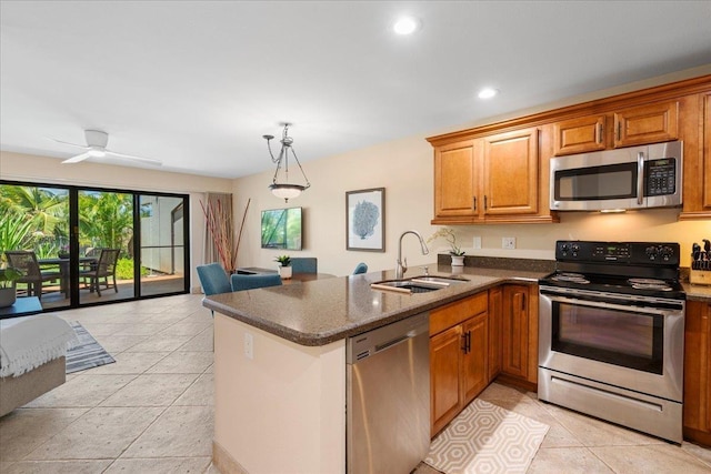 2777 S Kihei Rd Unit L-109, Kihei, HI 96753 - kitchen featuring stainless steel appliances, a peninsula, brown cabinets, recessed lighting, and dark stone countertops