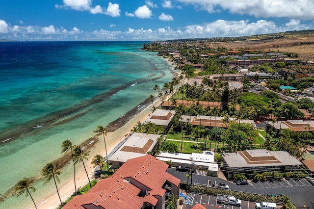 birds eye view of property with a water view and a beach view