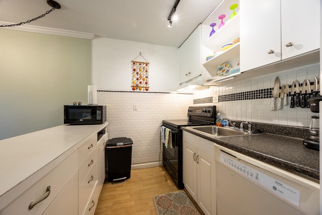 kitchen with white cabinets, white appliances, light hardwood / wood-style floors, and sink