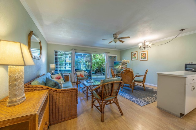 living room with ceiling fan with notable chandelier, crown molding, and light hardwood / wood-style floors