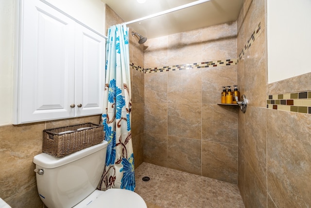 bathroom with tile walls, toilet, and a shower with curtain