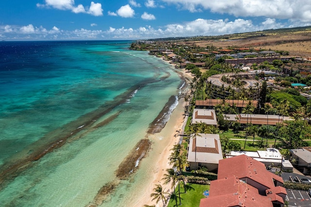 drone / aerial view with a water view and a beach view