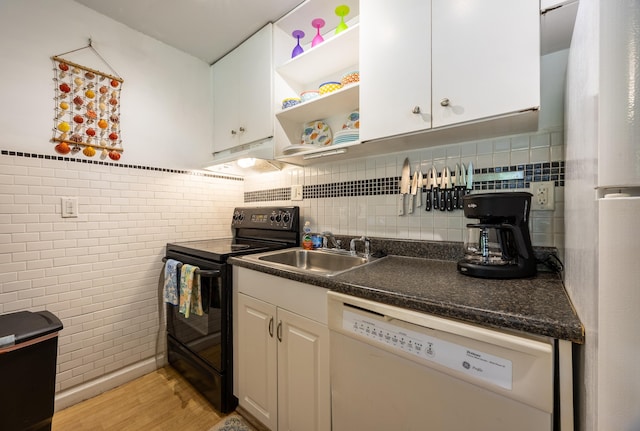 kitchen with sink, white cabinetry, tasteful backsplash, white appliances, and light hardwood / wood-style floors