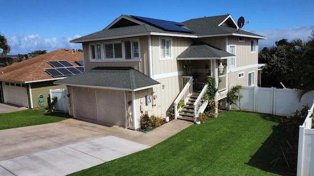 view of front facade with a front yard and solar panels