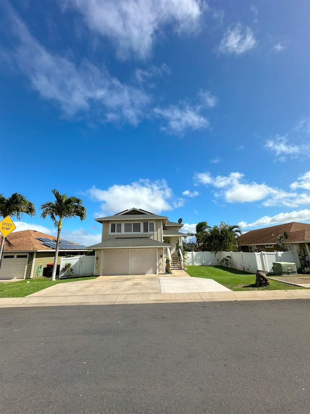 view of front of home featuring a front yard and a garage