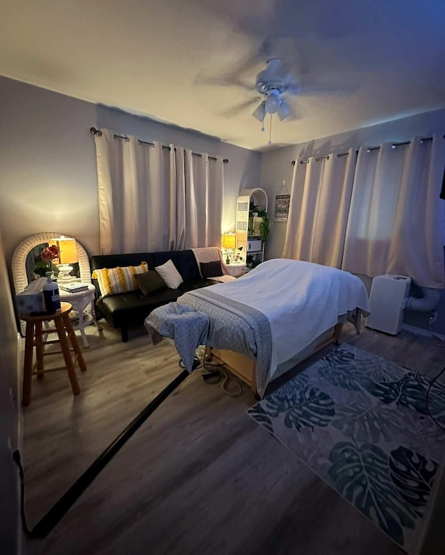 bedroom featuring hardwood / wood-style floors and ceiling fan