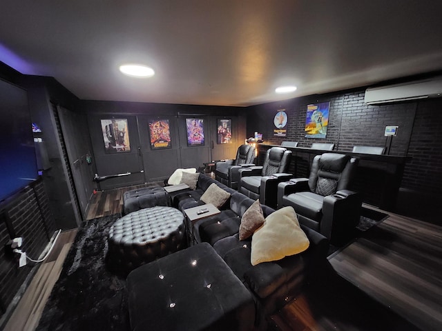 home theater room featuring a wall mounted AC and brick wall