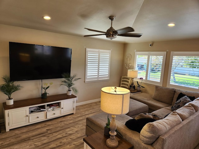 living room featuring hardwood / wood-style flooring and ceiling fan