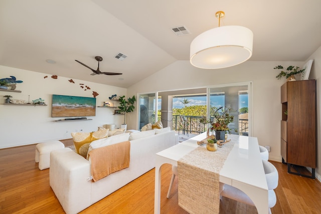 dining area featuring light wood-type flooring, vaulted ceiling, and ceiling fan