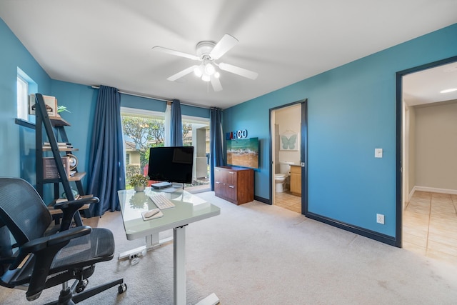 office area featuring light carpet and ceiling fan