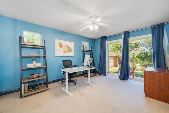 carpeted office featuring ceiling fan