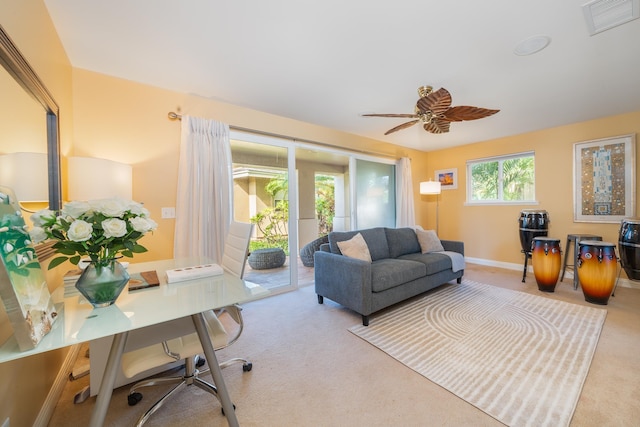 living room featuring carpet floors and ceiling fan