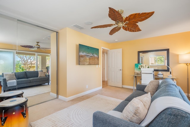 carpeted living room featuring ceiling fan