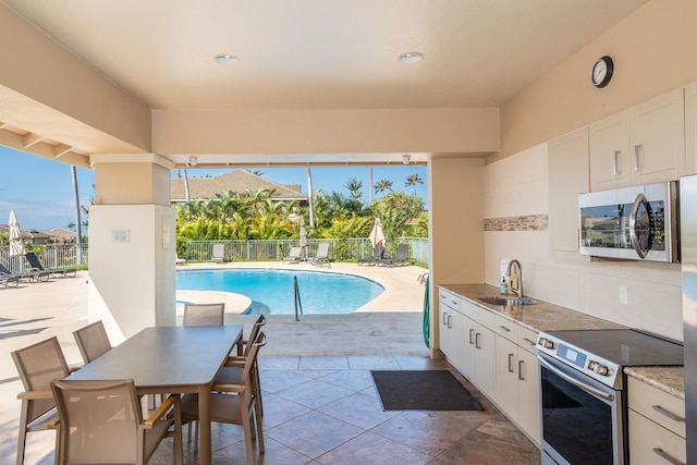 view of pool with sink