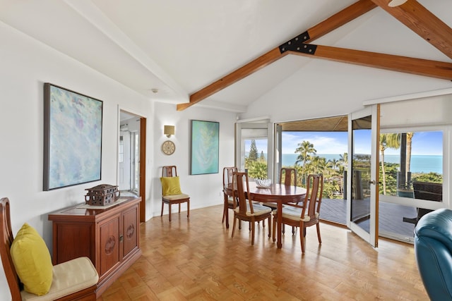 dining space featuring beam ceiling, a water view, and high vaulted ceiling