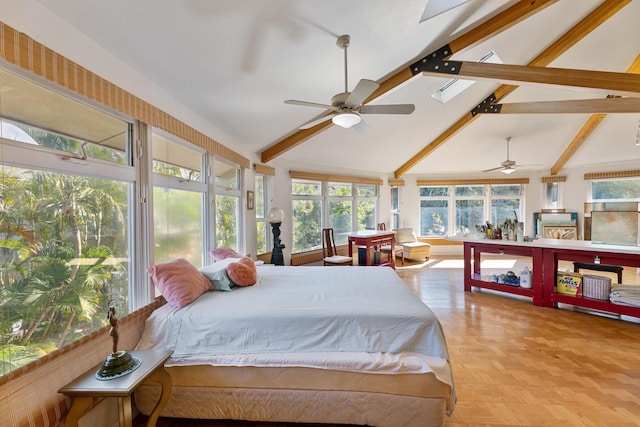 bedroom with beam ceiling, light parquet floors, and multiple windows