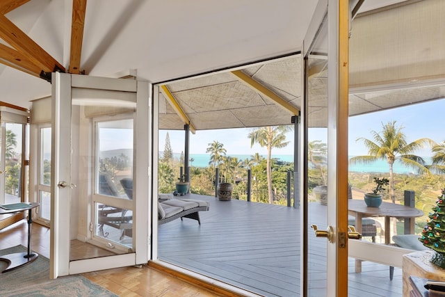 doorway to outside featuring plenty of natural light, a water view, french doors, and parquet flooring