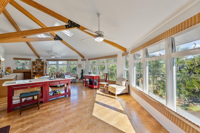 sunroom featuring vaulted ceiling with beams and ceiling fan