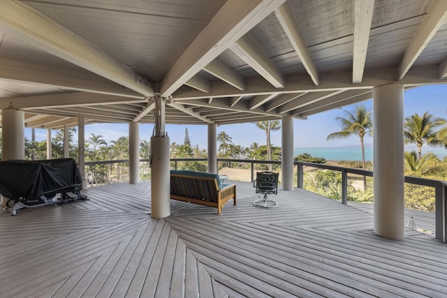 wooden terrace with area for grilling and a water view