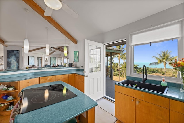 kitchen featuring black electric stovetop, lofted ceiling with beams, sink, hanging light fixtures, and ceiling fan