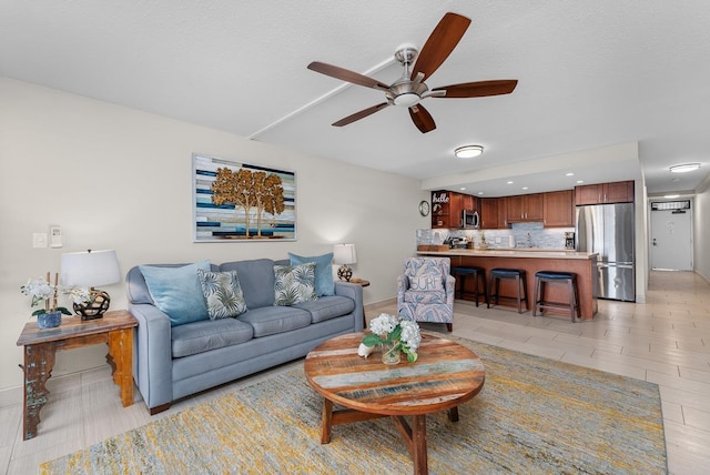 living room featuring a textured ceiling and ceiling fan