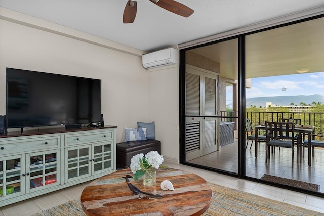 living room with a mountain view, an AC wall unit, expansive windows, and ceiling fan