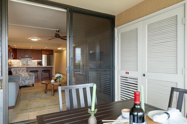 dining area with ceiling fan and wood-type flooring