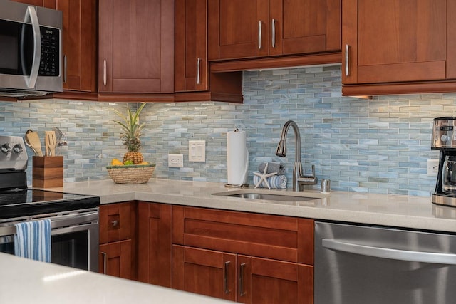 kitchen featuring stainless steel appliances, sink, and decorative backsplash