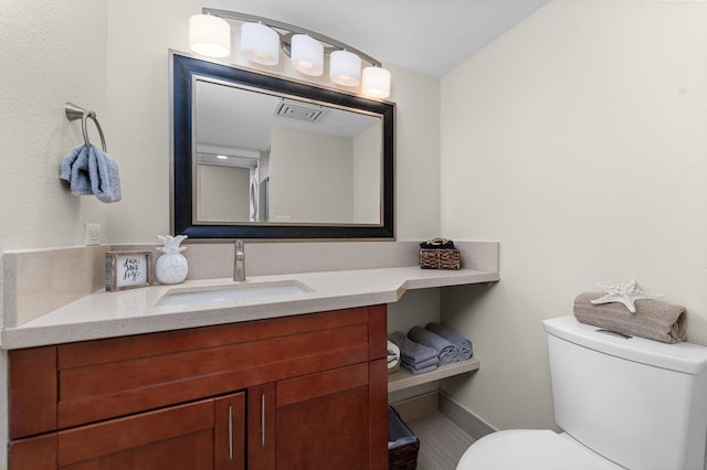 bathroom featuring vanity and toilet