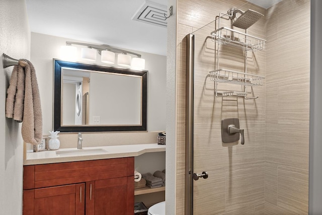 bathroom featuring vanity and an enclosed shower