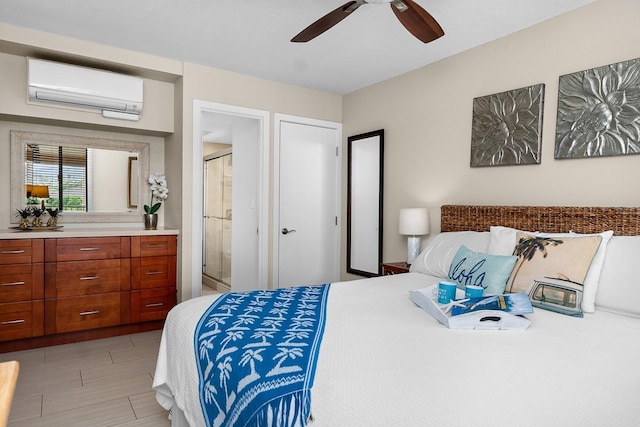 bedroom with a wall mounted AC, ceiling fan, and ensuite bathroom