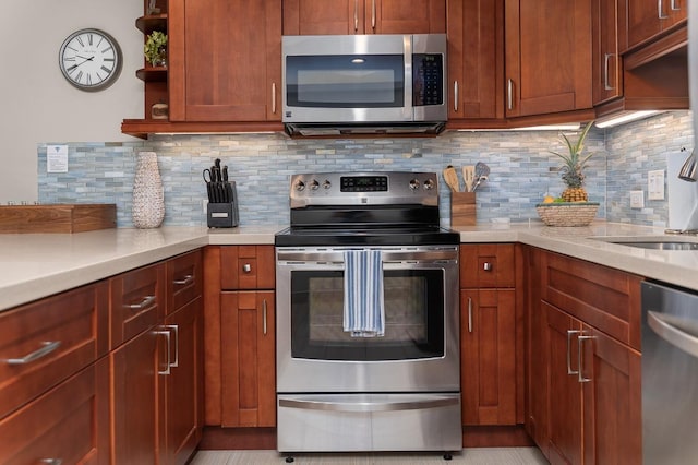 kitchen with appliances with stainless steel finishes, sink, and backsplash