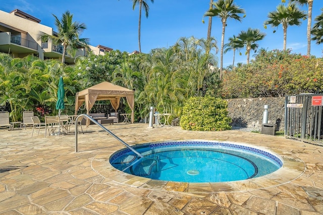 view of pool with a hot tub and a gazebo