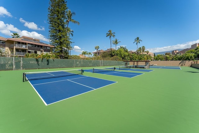 view of tennis court with basketball hoop