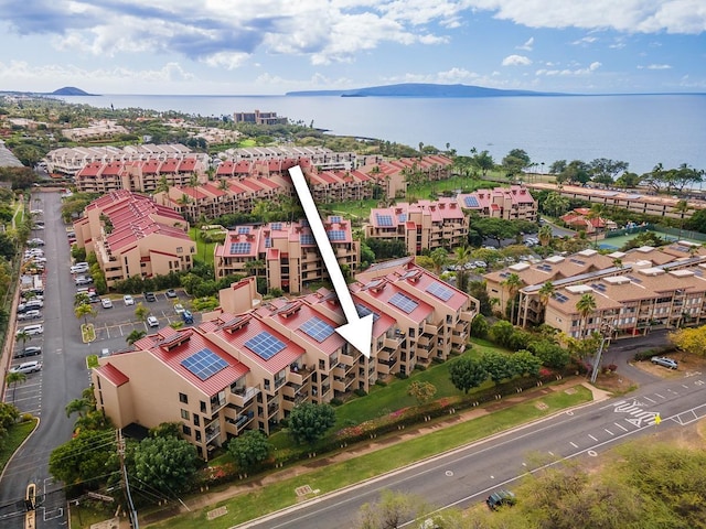 birds eye view of property with a water and mountain view