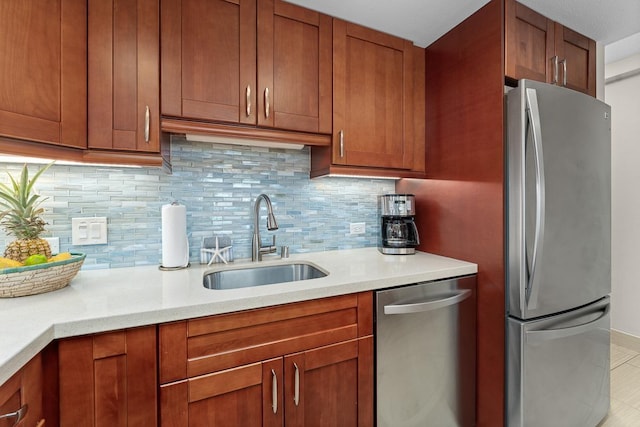 kitchen featuring stainless steel appliances, sink, and decorative backsplash