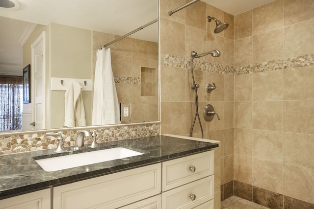 bathroom featuring vanity, decorative backsplash, and walk in shower