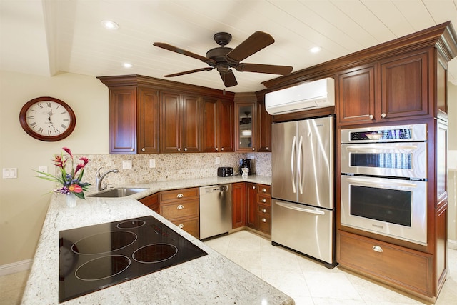 kitchen with sink, stainless steel appliances, a wall mounted air conditioner, light stone countertops, and decorative backsplash