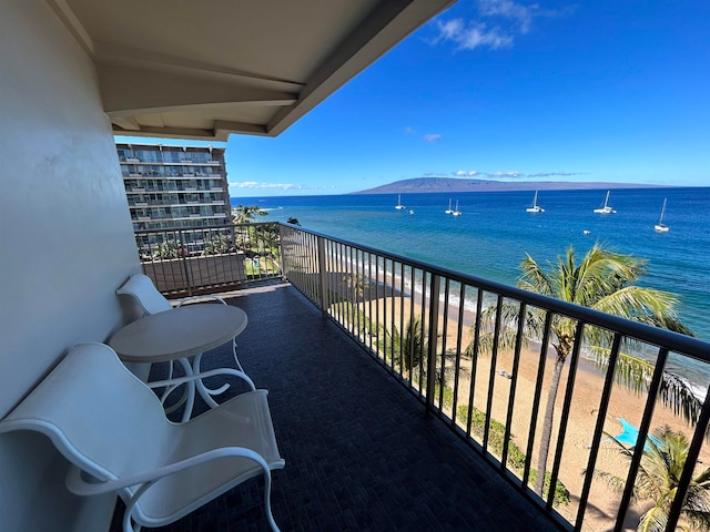 balcony featuring a water and mountain view