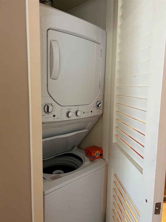 clothes washing area with stacked washer and dryer