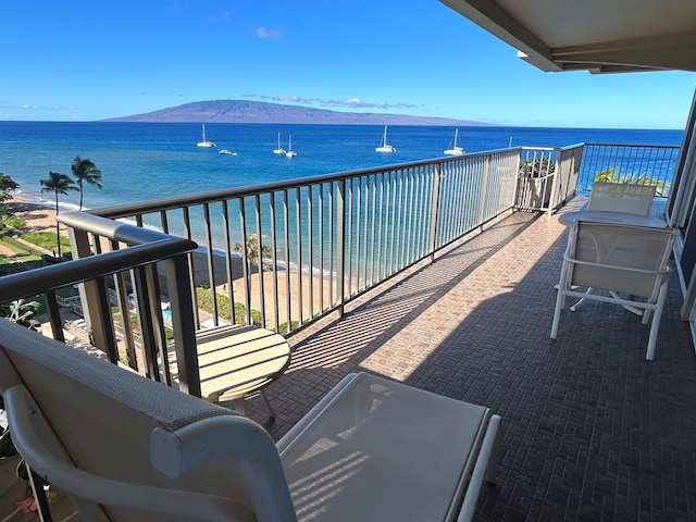 balcony featuring a water and mountain view