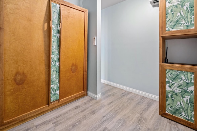 3788 Lower Honoapiilani Rd Unit C102, Lahaina, HI 96761 - bathroom featuring wood finished floors, baseboards, and a wall unit AC