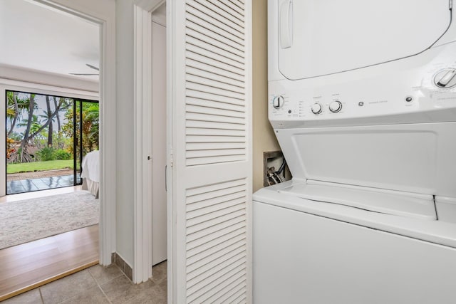3788 Lower Honoapiilani Rd Unit C102, Lahaina, HI 96761 - laundry room featuring stacked washing machine and dryer and light tile patterned floors