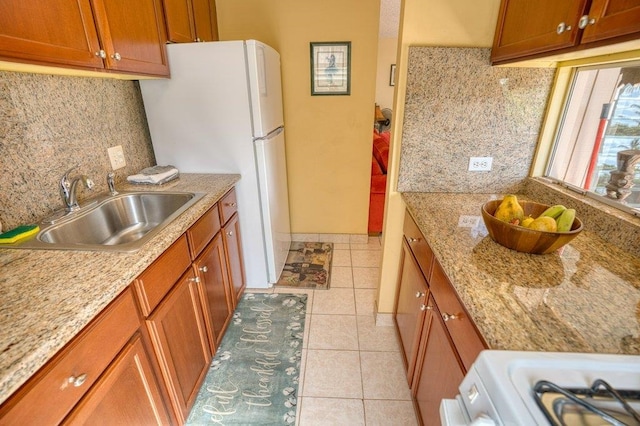 kitchen featuring light tile patterned floors, backsplash, sink, and white appliances